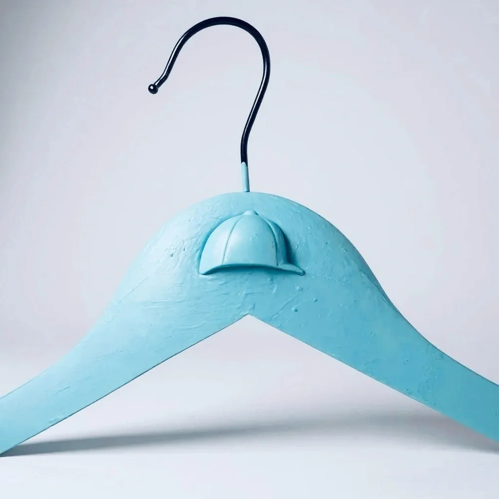 Teal Hanger with Angled Shoulders for the Equestrian attire adorned with helmet.